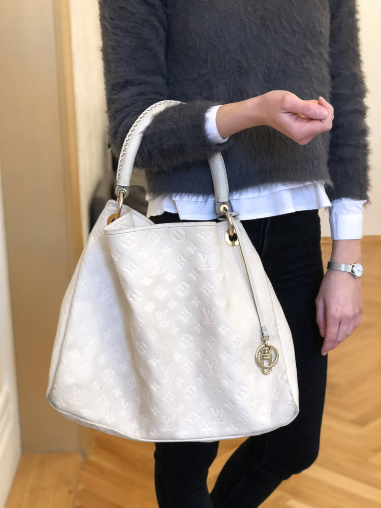 Experience the enchanting beauty of the Louis Vuitton Artsy MM Neige Monogram  Empreinte Leather Bag as you gracefully drape it over your…